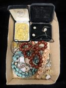 A small group of costume jewellery, gold plated dress rings, cherry and butterscotch colour beads,