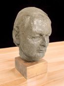 A composition bust of a man, possibly a young Winston Churchill, on pine plinth, height 35 cm.