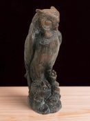 A heavy cast resin figure of an owl, height 38 cm.