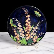 A Maling lustre cabinet plate depicting butterflies and delphiniums, Pattern No.