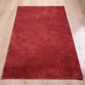 A contemporary Burgundy rug, 120 cm x 170 cm.
