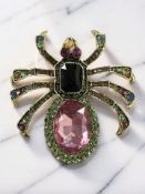 A large encrusted multi synthetic gem spider brooch, length 7.