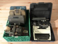 A group of vintage typewriters, adding machine, etc.