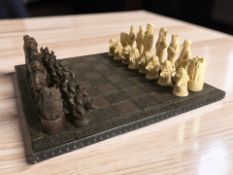 A Elizabethan-themed resin chessboard and set of pieces, board 46 cm wide, kings 13 cm.