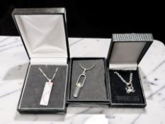 Three boxed silver necklaces, rock crystal, mother of pearl, etc.
