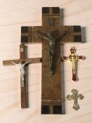 A burr wood wall crucifix with brass mounts, length 35 cm, and several other crucifixes.