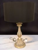 A contemporary gilt table lamp with shade, height 79 cm.
