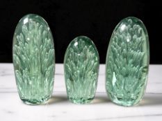 Three Victorian Sunderland green glass dumps with bubble inclusions, tallest 17 cm.