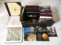 A collection of empty collector's coin folders and wooden cases.