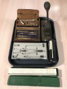 A group of precision drawing sets, rules, desk punch, logarithmic scale, etc.