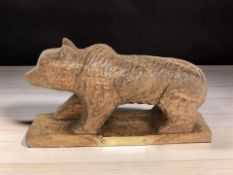 An adzed oak figure of a bear with brass plaque inscribed 'Presented by Mrs E.