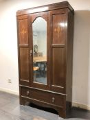 An Edwardian mahogany and satinwood inlaid mirror door wardrobe, 103 cm x 44 cm x 195 cm.