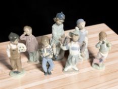 Seven Nao figures of children, tallest 26 cm.