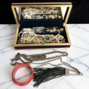 A contemporary jewellery box and contents including a Chinese cinnabar bangle, gilt metal chains,