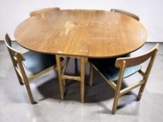 A 1960's teak gateleg drop leaf oval dining table, 148 cm x 114 cm x 73 cm,