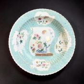 A Chinese famille rose ribbed porcelain charger decorated with butterflies and other insects