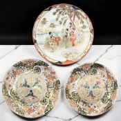 A Japanese Kutani porcelain charger depicting a group of ladies walking the bank of a river in