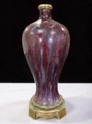 A Chinese Sang de Boeuf porcelain baluster vase, 19th century, converted to a table lamp,