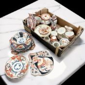 A collection of Japanese Kutani and Imari porcelain including tea wares, vases,