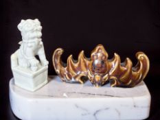 A Chinese blanc de chine foo dog on plinth, height 11.