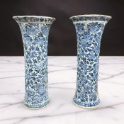 A pair of Chinese blue and white porcelain sleeve vases, Kangxi period, of flared trumpet form,