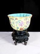 A Chinese famille rose yellow-ground cup, Qing Dynasty,