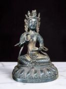 A Sino-Tibetan hollow cast patinated bronze figure of Green Tara, height 20 cm.