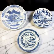 A Chinese blue and white porcelain plate/charger depicting a fishing village beneath mountains,