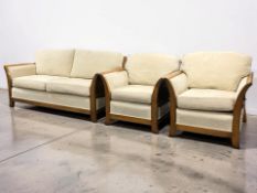 A contemporary wooden framed three piece lounge suite, settee 195 cm long.