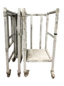 An aluminium decorator's platform on trolley castors.