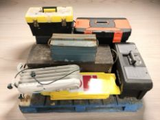 A group of wooden and plastic toolboxes, electric radiator, etc.