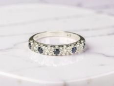 An 18ct white gold sapphire and diamond half-eternity ring,