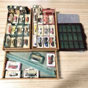 Three glazed pine collector's cases containing boxed Days Gone die cast vehicles,