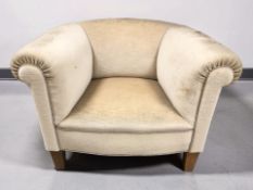 A 20th century cream dralon upholstered armchair, width 95 cm.