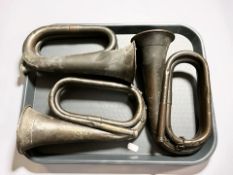 Three antique bugles.
