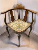 An Edwardian inlaid walnut corner armchair with tapestry seat.