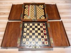 A mahogany cased folding Jacques-type chess board and pieces,
