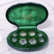 A set of eight Edward VII silver buttons, Birmingham 1908, in original velvet-lined case.