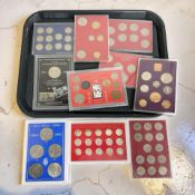 A group of plastic-encased British coin sets