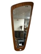 A 1970's teak backed wall mirror, height 74 cm.