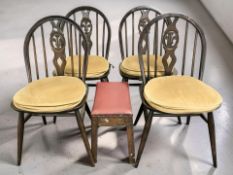 A set of four Ercol dark elm Fleur de Lis spindle back dining chairs,