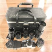An Olympus OM-2 camera outfit comprising camera with f=50mm lens, six further lenses,