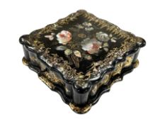 A Victorian papier maché games box containing bone gaming counters and further gilt and
