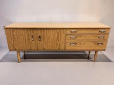 A 20th century teak veneered low sideboard, 177 cm x 44 cm x 73 cm.