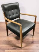 A 20th century Scandinavian teak and black vinyl armchair, width 65 cm.