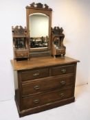 A late Victorian walnut four drawer mirror back dressing table, 107 cm x 51 cm x 169 cm.
