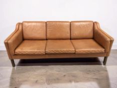A late 20th century Scandinavian three seater tan leather settee, length 182 cm.