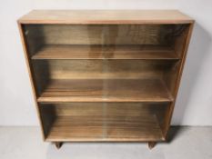 A 20th century teak sliding glass door bookcase, width 92 cm.