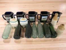 A group of glass bottles including J Kershaw & Sons, Gateshead, five Seton Pottery jugs,