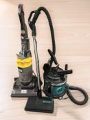 A Dyson vacuum cleaner and a Majestic vacuum cleaner.